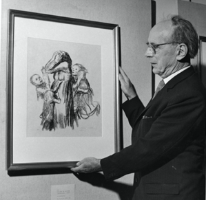 Black and white image of a man holding a painting