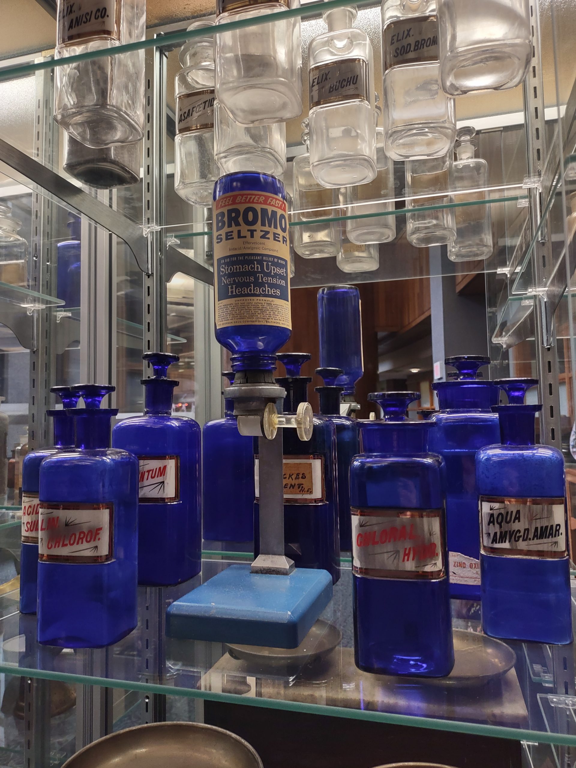 glass pharmacy bottles in a display case